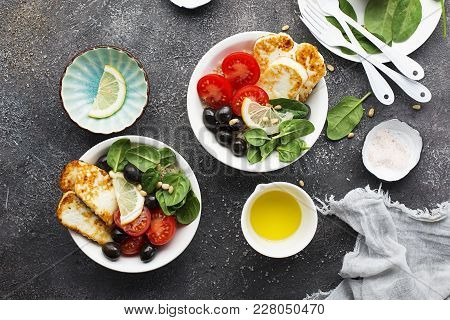 Cheese Haloumi Brown Rice Bowl With Tomatoes, Olives, Lemon And Pine Nuts. Top View.