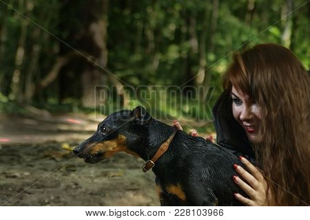 Dog Hunter In The Hands Of A Young Witch In The Woods