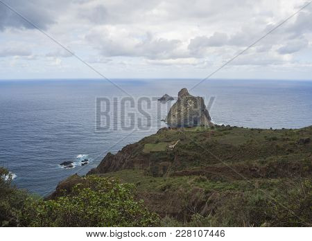 View On Rock In The Sea El Draguillo With Green Hills And Dramatic Blue Sky White Clouds In Anaga Mo
