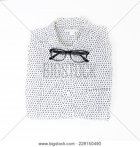 Glasses Lie On The White Neatly Folded Men Shirt With A Long Sleeve Instead Of A Bow Tie