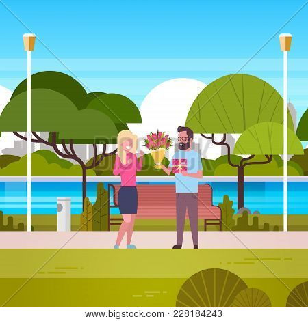 Man Give Girl Gift And Bouquet Over Green Park Background Congradulations For International Women Da