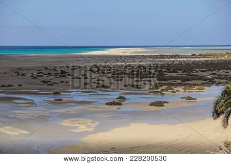 Mud Flats At Low Tide Off The Coast Of Canary Island .