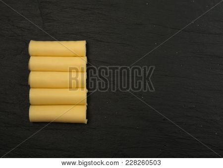 Sliced Cheese Over Stone Background