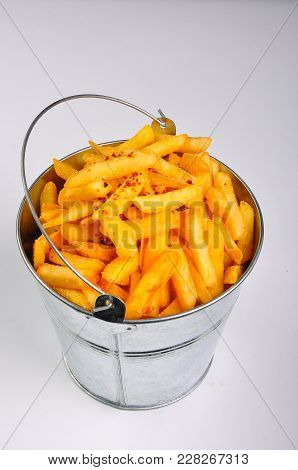 Yellow Rench Fries In A Metal Pail On A White Background