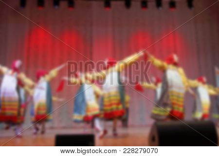 Folk Dances Of Children And Teens Theme Abstract Blur Background With Bokeh Effect. Teens In Bright 