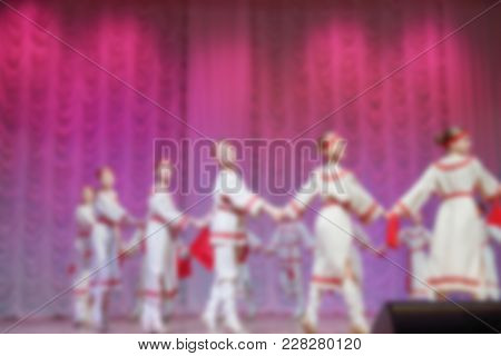 Folk Dances Of Children And Teens Theme Abstract Blur Background With Bokeh Effect. Teens In Bright 