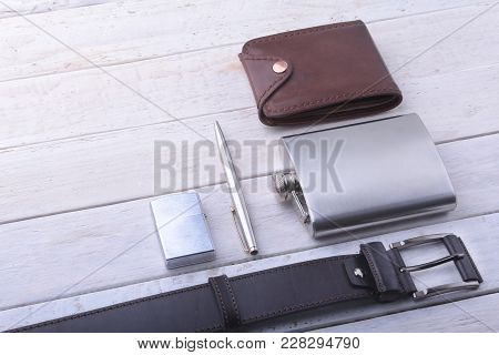 Gadgets And Accessories For Men On Light Wooden Background. Fashionable Men S Belt, Wallet, Lighter,