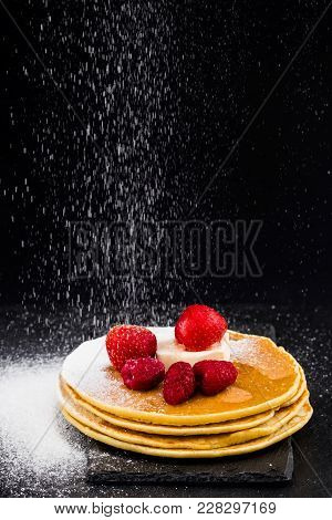 Pancakes With Berries And Sugar On Dark Background.