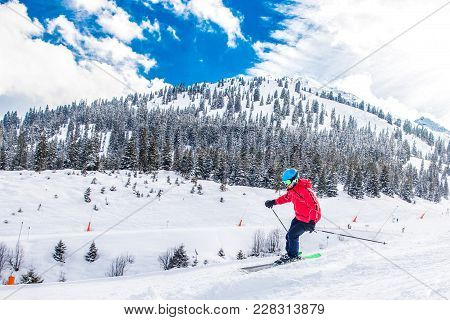 Man Skiing On The Prepared Slope With Fresh New Powder Snow.