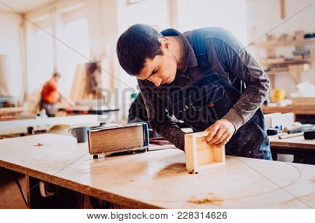 Processing Of A Furniture Part By A Machine For Polishing A Wooden Furniture Detail. Toned Image.