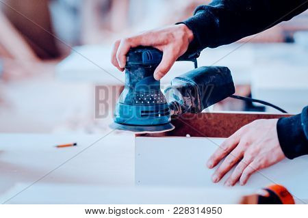 Processing Of Polishing Of Furniture Part By A Machine For Polishing A Tree. Toned Image.
