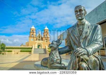 Geraldton, Australia - Dec 18, 2017: Statue Of Monsignor John Hawes On Foregound With St. Francis Xa