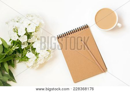 Coffee With Milk, Phlox Flower, Scretch-book On White Table From Above. Female Working And Creative 