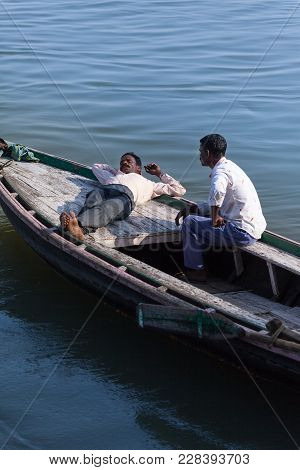 Midday Rest Of The Indian Boatmen Onboard The Wooden Boat, Before Flows Of Tourists, On The Bank Of 