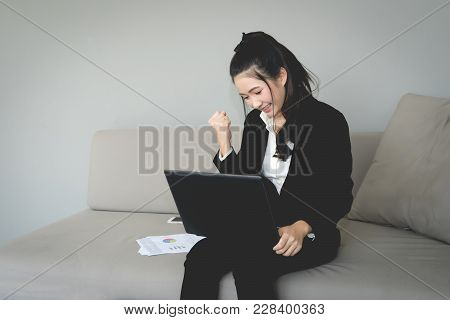 Happy Young Woman With Fists Up, Air Punch.
Business Girl  In Black Suit Punching In The Air.
Victor