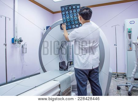 Doctor Or Radiologist In Hospital Looking  Ct Scan Image Of The Brain .