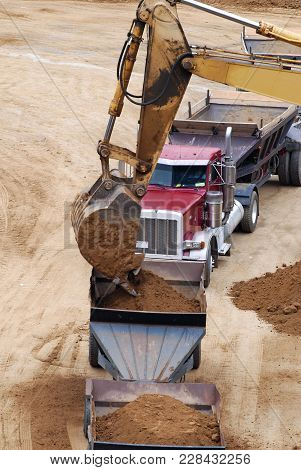 The Modern Excavator Performs Excavation Work On The Construction Site