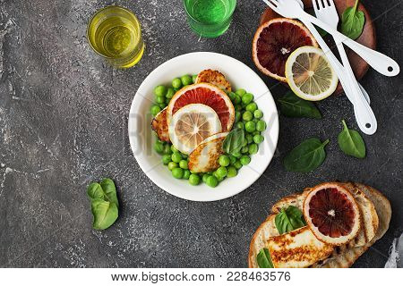 Green Young Peas, Cheese Haloumi, Lemon. Orange Salad With Slices Of Bread. Top View.