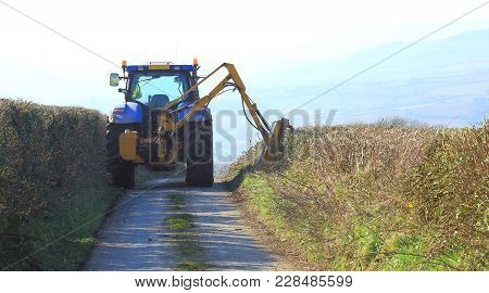 Tractor Mounted Hedge Cutter On A Country Road In East Devon