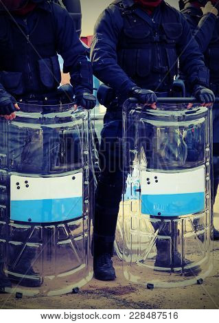 Anti-riot Police Officers With Bullets And Protective Shields With Vintage Effect