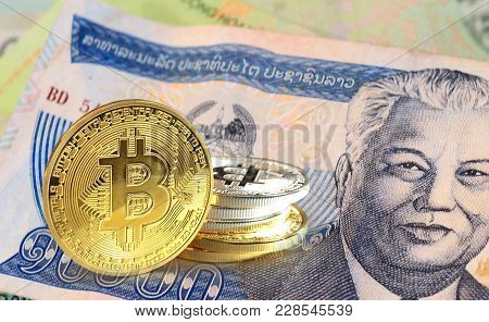 Bitcoin Coins On Laotian Kip Banknote, Cryptocurrency Concept Photo