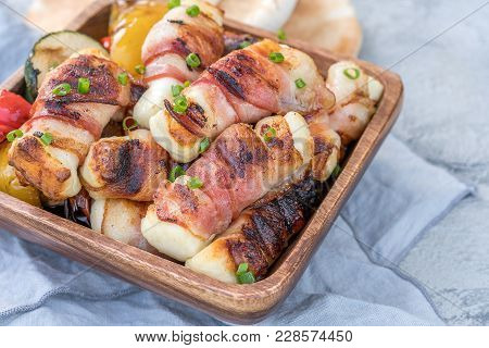 Grilled Bacon Wrapped Haloumi Cheese With Vegetables And Pita