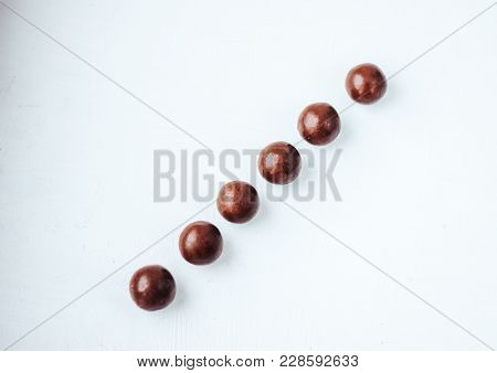 Line Of Chocolate Balls Bon Bon On Concrete Grey Background