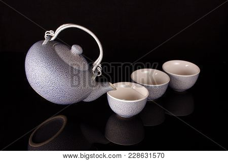 Old Style Kettle And Coffee Cups In Creative Still Life With Flying Kettle