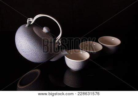 Old Style Kettle And Coffee Cups In Creative Still Life With Flying Kettle