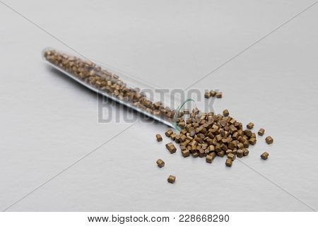 Plastic Pallets . Plastic Raw Materials In Granules For Industry.polymeric Dye Gold On A Silver Back