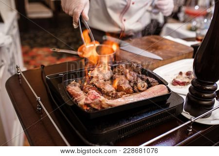 Hand Of Grilling Some Meat And Meat Ball On Hot Flame.