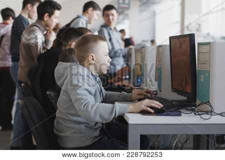 ST. PETERSBURG, RUSSIA - FEBRUARY 23, 2018: People playing old computer games on the exhibition of retro computers during St. Petersburg Cyber-Sport Festival. Main event is Counter-Strike tournament