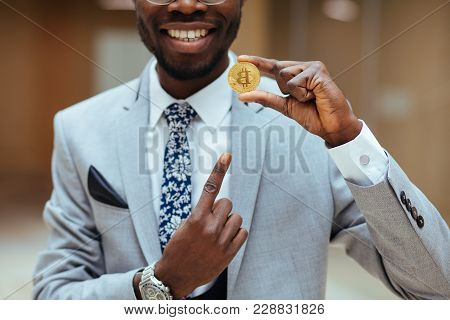 Golden Bitcoin In African Man Hand, Businessman Holding Digitall Symbol Of New Virtual Currency