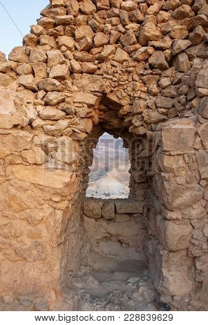 Vertical Picture Of The Window Bulit With Rocks In The Fortress Located In Massada, Israel