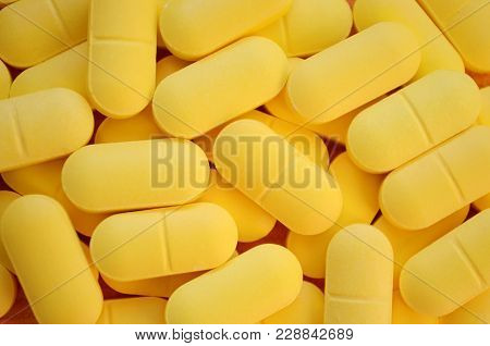Many Oval Yellow Pills For A Background