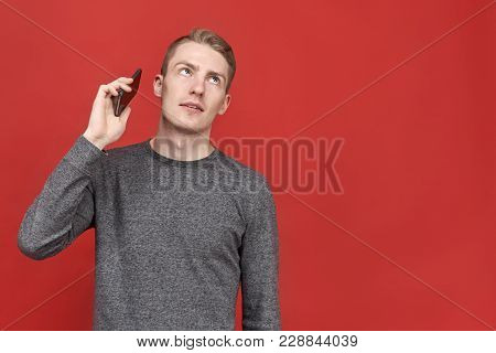 Young Handsome Man Looking Up From Annoying Boring Conversation On Phone. Businessman Tired Of Const