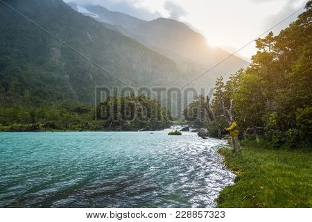 Angler fishing on the river during harsh weather conditions. River of Exploradores in Chile