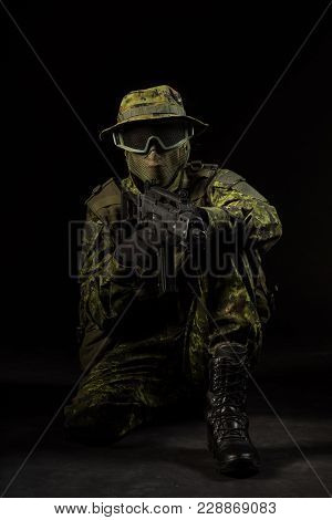 Portrait Of Armed Woman With Camouflage. Young Female Airsoft Sniper Observe With Firearm. Soldier W