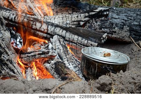 Black Metel Army Pot With Food On The Fire