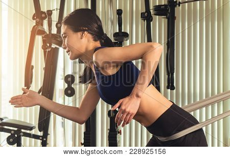 Woman Workingout With Resistance Elastic Band In Gym