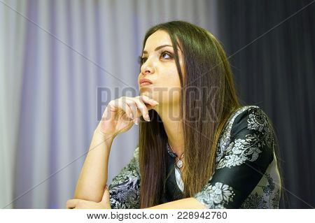 A Lonely Young Woman Sitting On The Couch At Home, She Is Depressed And Separated From Problems In H
