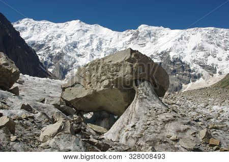 Hanging Stone On The Bezengi Glacier Against The Background Of The Bezengi Wall