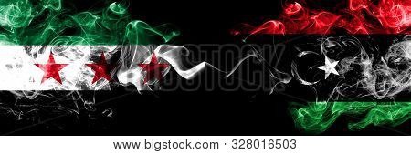 Syrian Arab Republic Vs Libya, Libyan Smoke Flags Placed Side By Side. Thick Colored Silky Smoke Fla