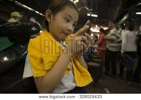 Siem Reap, Cambodia - January 19, 2011: Young Cambodian Girl Crazy By Her Smartphone In The Siemp Re