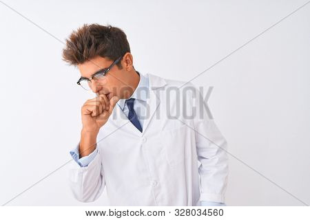 Young handsome sciencist man wearing glasses and coat over isolated white background feeling unwell and coughing as symptom for cold or bronchitis. Healthcare concept.