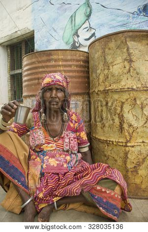 Hampi, Karnataka, India - September 26, 2010: Banjara Woman Relaxing Drinking Masala Chai