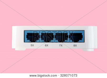 White 8 Port Plastic Ethernet Switch Isolated On Pink Background At Dry Day