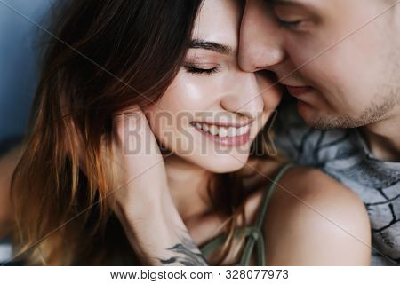 Kissing Couple Portrait. Young Couple Deeply In Love Sharing A Romantic Kiss