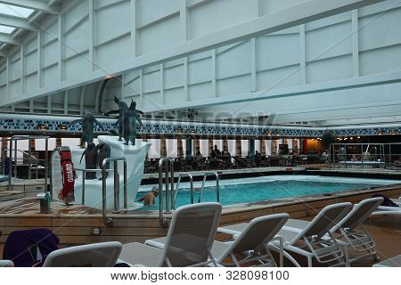 Victoria/canada-9/13/19: A Cruise Ship Indoor Pool And Hot Tub With Ornamental Penguins.