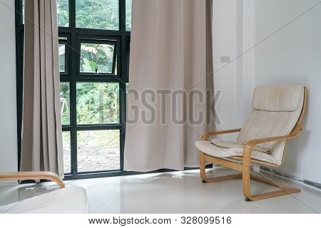 Wooden Armchair Sofa In Modern Room With Curtain On Glass Wondow